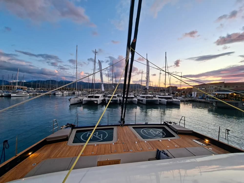 Catamarans dock at a Lefkas marina during sunset