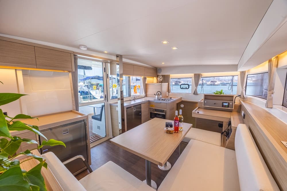 Interior of Lagoon 40 catamaran showing saloon, galley, and dining area – Lagoon 40 review highlighting catamaran layout for sailing holidays and yacht charters.