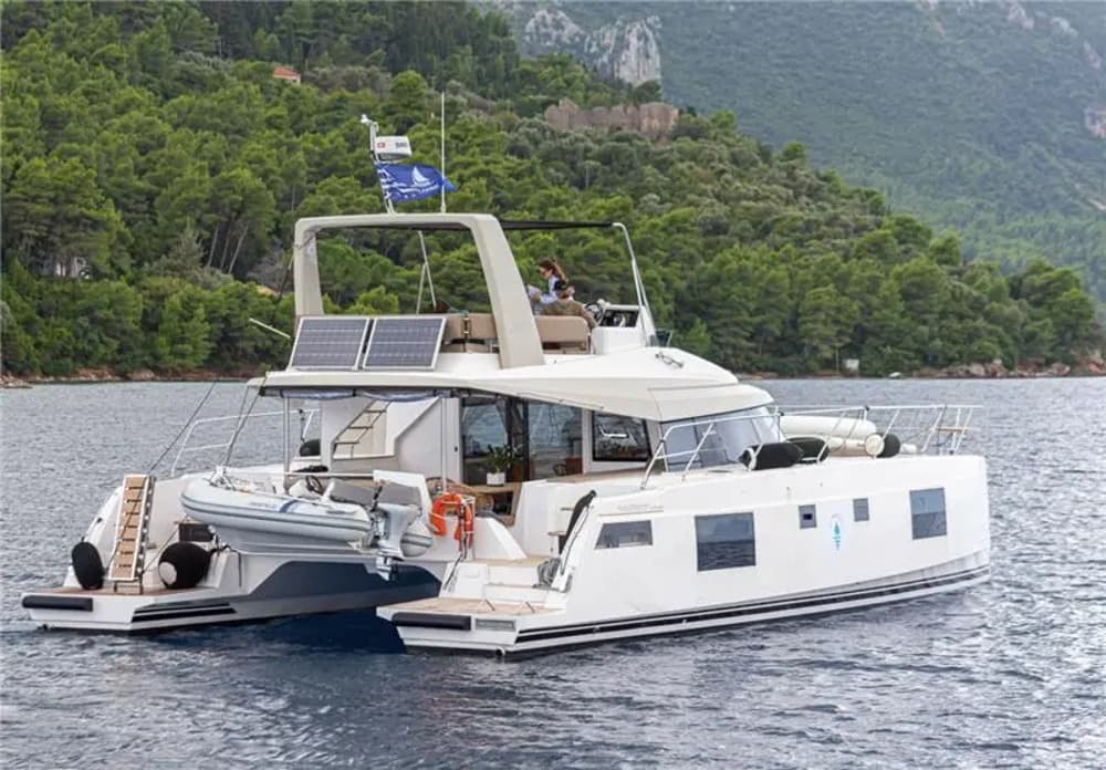 power catamaran in beautiful greek island landscape