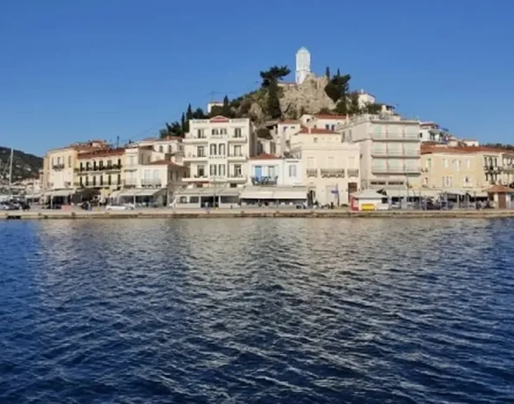 Scenic view of a coastal village near Athens, showcasing an idyllic sailing destination for friends.