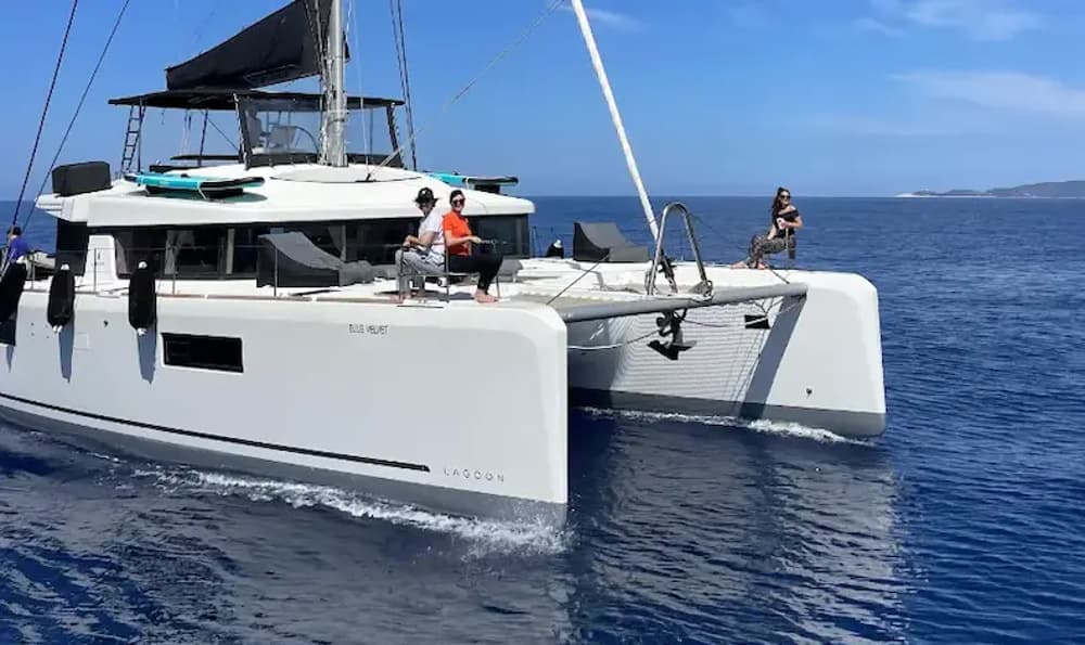 a group of friends enjoying a sunny morning on board a bareboat catamaran charter in the mediterranean