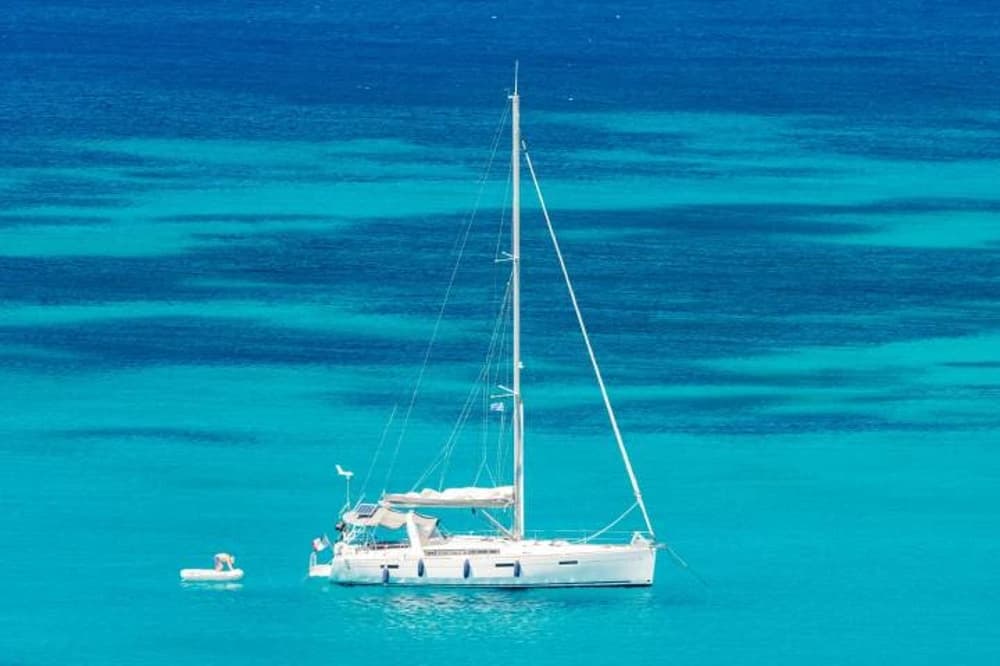 Luxury sailboat floating in crystal-clear waters, epitomising the best options for Mediterranean sailing holidays.