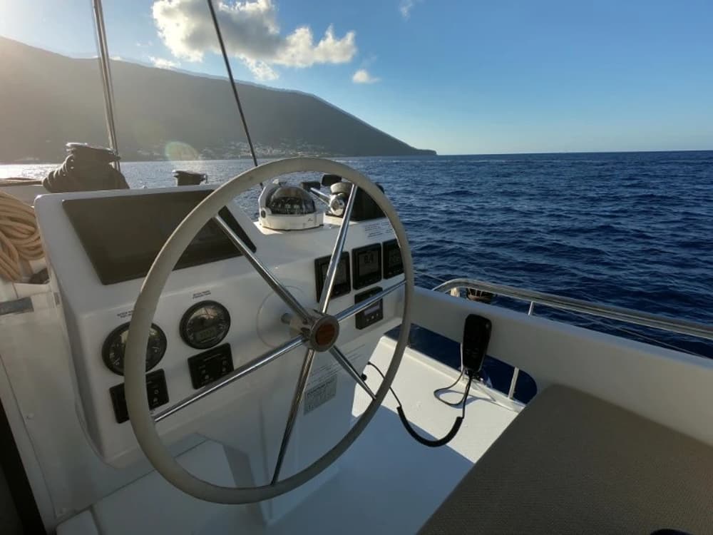 Catamaran helm station with navigation instruments, offering stability and panoramic sea views.