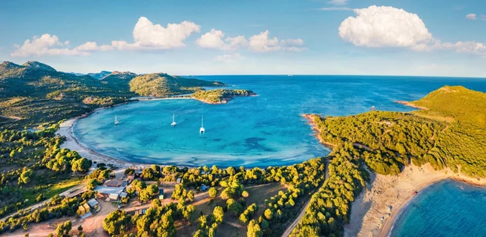 Sailing the rugged coastline of Corsica, France – a challenging sailing destination requiring an advanced sailing experience level.