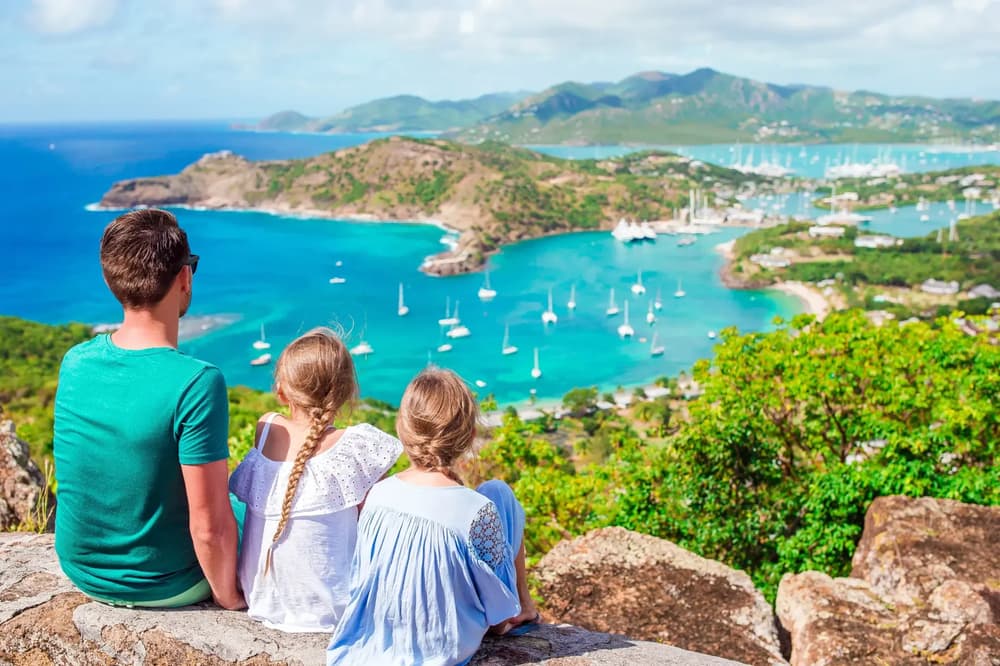 family overlooking view of Antigua on a family sailing holiday