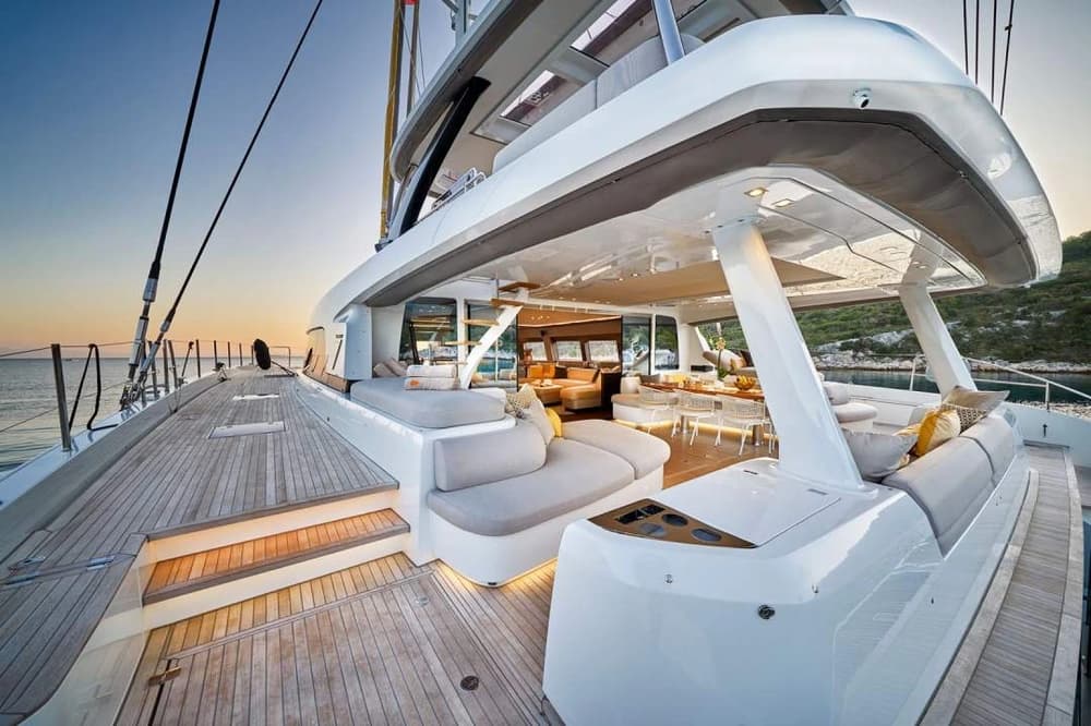 The elegant aft deck of the Lagoon 77 featuring stylish seating, dining space, and open-air comfort, perfect for relaxation and socializing during a luxury yacht charter.