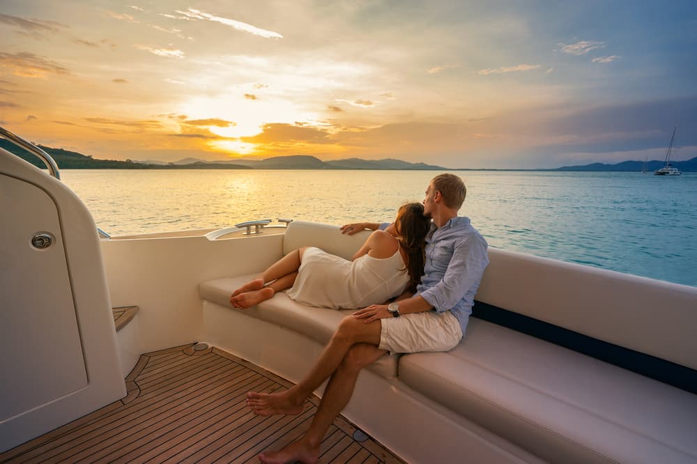 couple enjoying a relaxing evening at the back of a boat