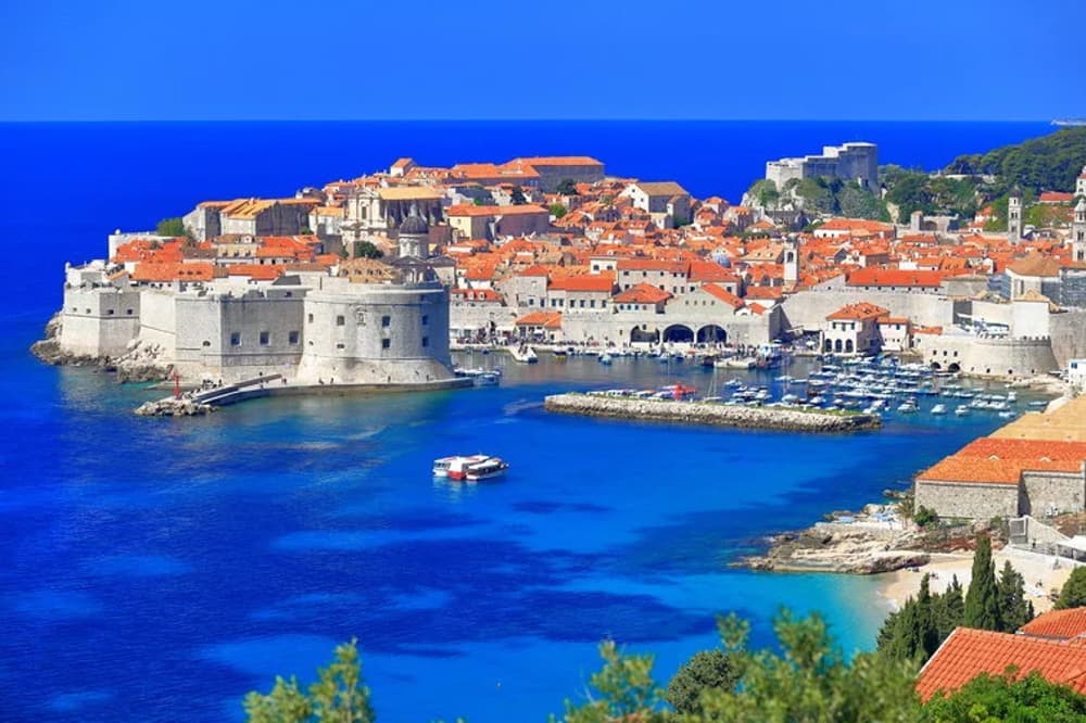 Dubrovnik's old town and marina surrounded by historic walls, a must-visit on Croatian sailing holiday itineraries.