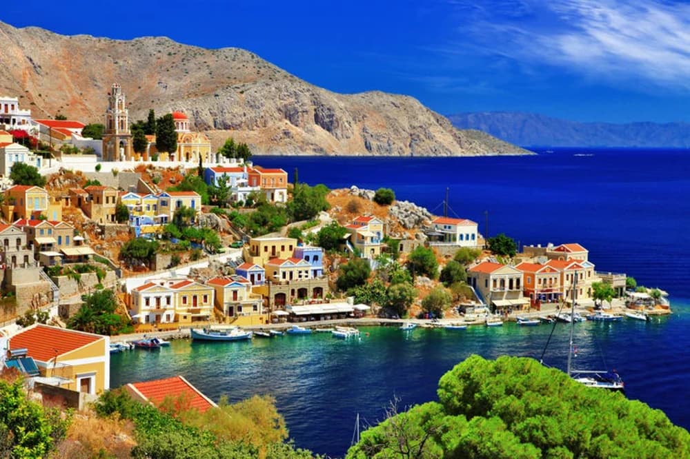 The colourful harbour of Symi Island, a picturesque destination on a Dodecanese sailing holiday in Greece.