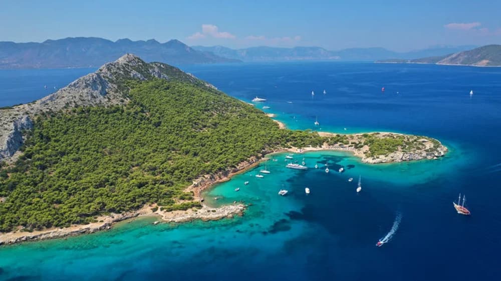 A picturesque view of a secluded island bay near Athens, perfect for a Greek sailing holiday experience.