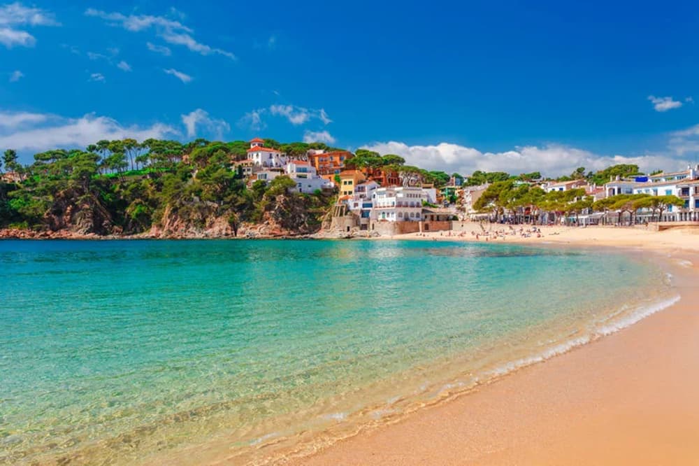 Charming coastal village in Costa Brava with crystal-clear waters, a top destination for sailing holidays in Spain.