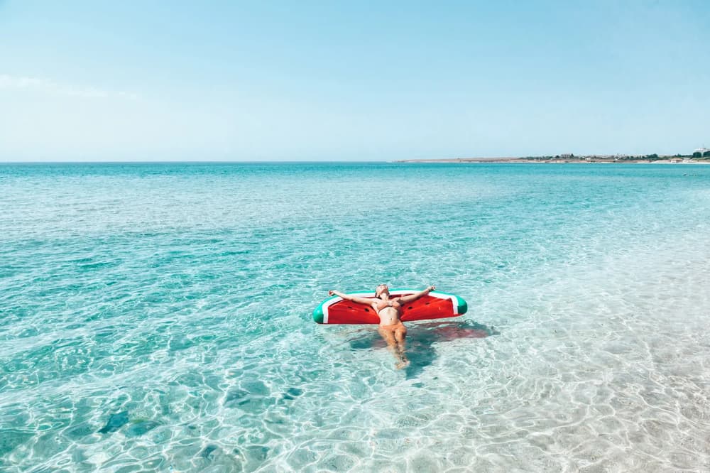 Woman swiming with a watermelon floatie
