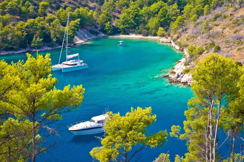boats in idyllic scenery with blue waters and green surroundings