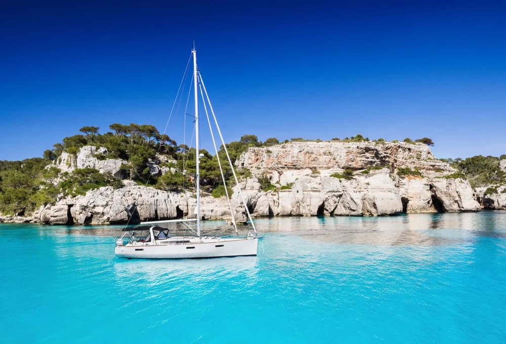 boat anchored in turquoise waters in Mallorca