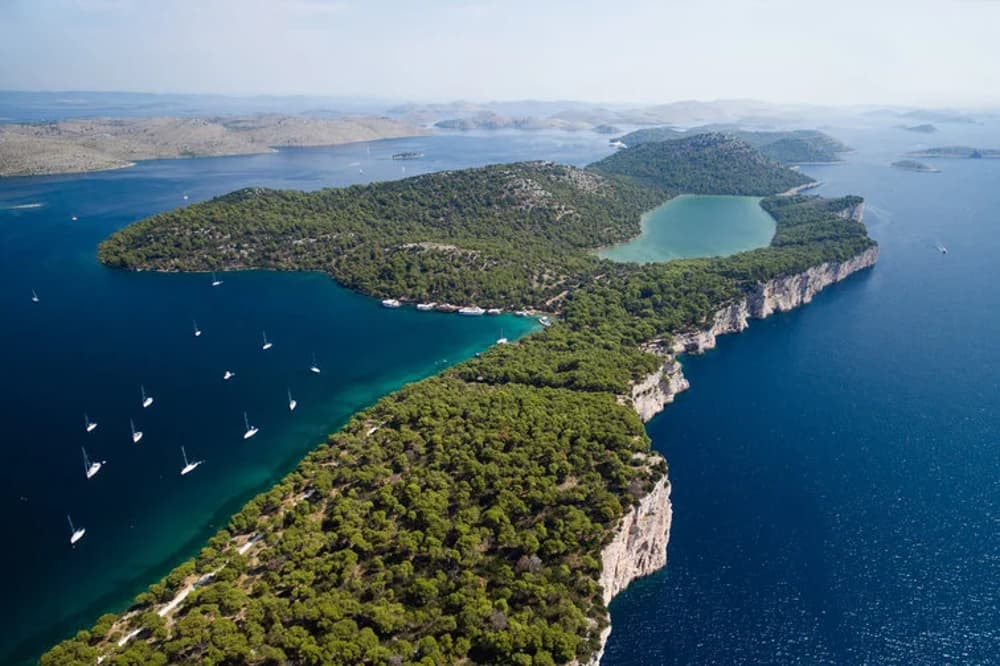 Aerial view of Kornati National Park in Croatia, with dozens of sailboats exploring its untouched islands – a dream destination for sailors.