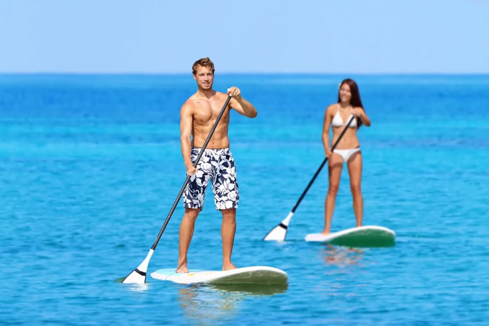 couple on paddleboars enjoyins valentines day on a sailing holiday