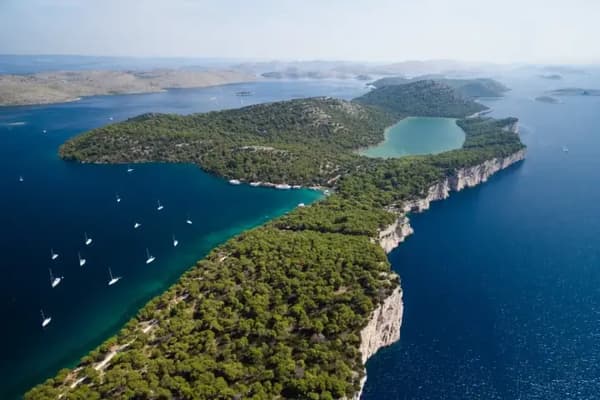 Aerial view of the Kornati Islands, Croatia, showcasing lush green landscapes and deep blue waters, ideal for a sailing holiday in the Kornati archipelago.