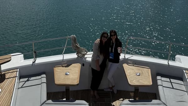 Aerial view of multiple yachts anchored near the coastline, ideal for corporate sailing events with Yacht4Less.
