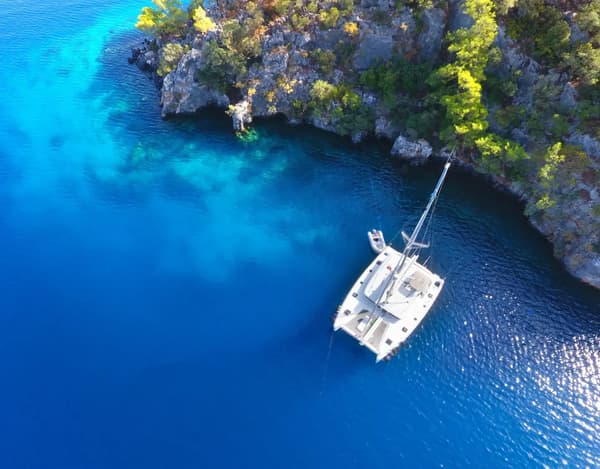 Group enjoying water activities during a sailing holiday, highlighting the contrast with traditional land-based vacations for unique holiday experiences.