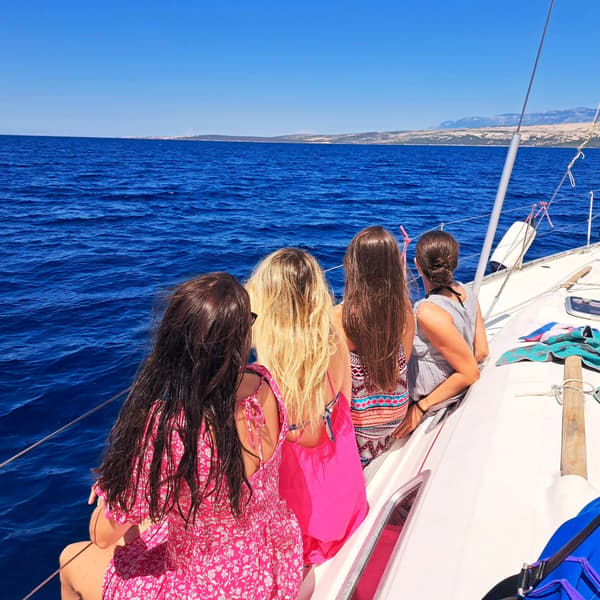 Woman enjoying a sunny day on a sailing catamaran near Athens, Greece.
