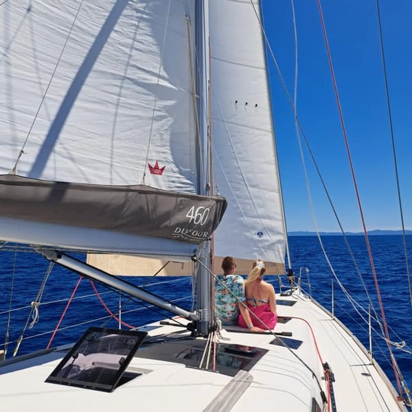 Romantic mojito cocktail at sunset on a yacht, perfect for Valentine's Day sailing holidays.